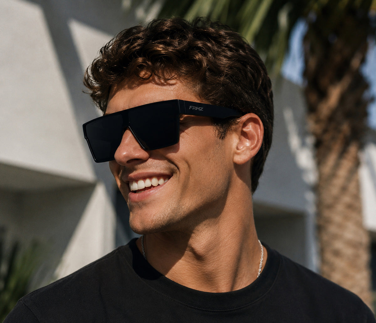 Male model wearing FRMZ black flat-top shield sunglasses outdoors
